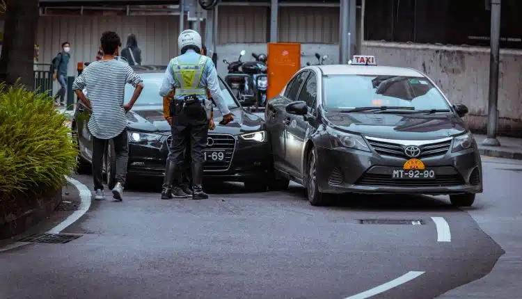 man in white and black stripe shirt and black pants standing beside black car during daytime