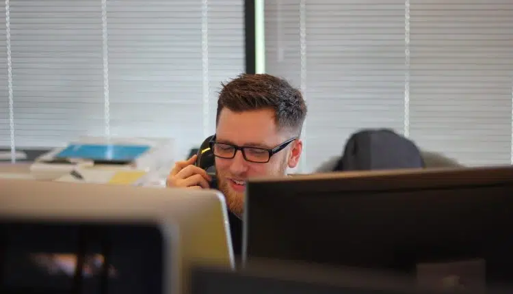 man using IP phone inside room